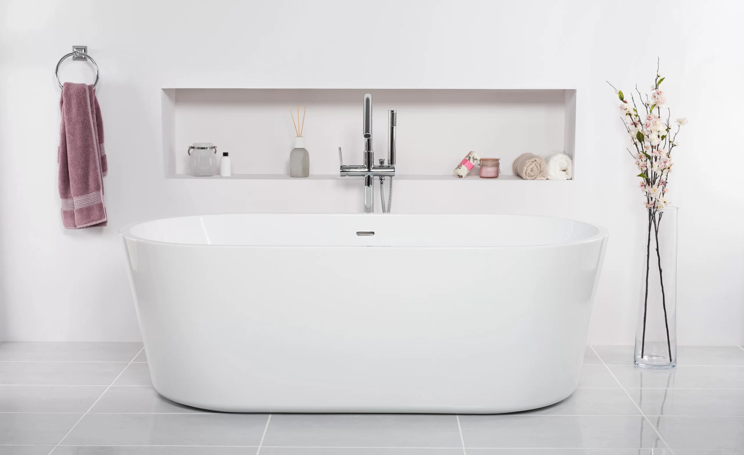 bathtub-white-bathroom-with-flowers-vase-tub-skincare-products-rack-1